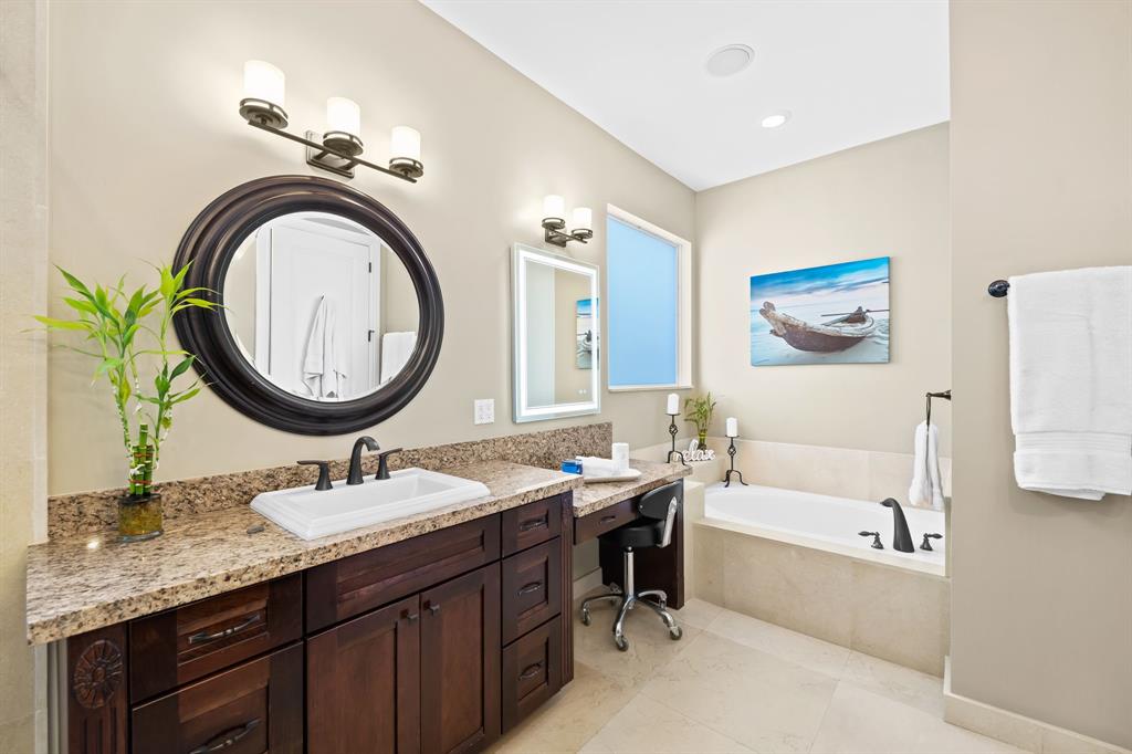 909 Turner Road Delray Beach, FL 33483 - Photo 21 of 50 a bathroom with a sink a bathtub a mirror and a bathtub