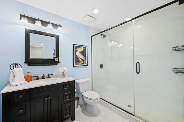 a bathroom with a toilet sink and shower