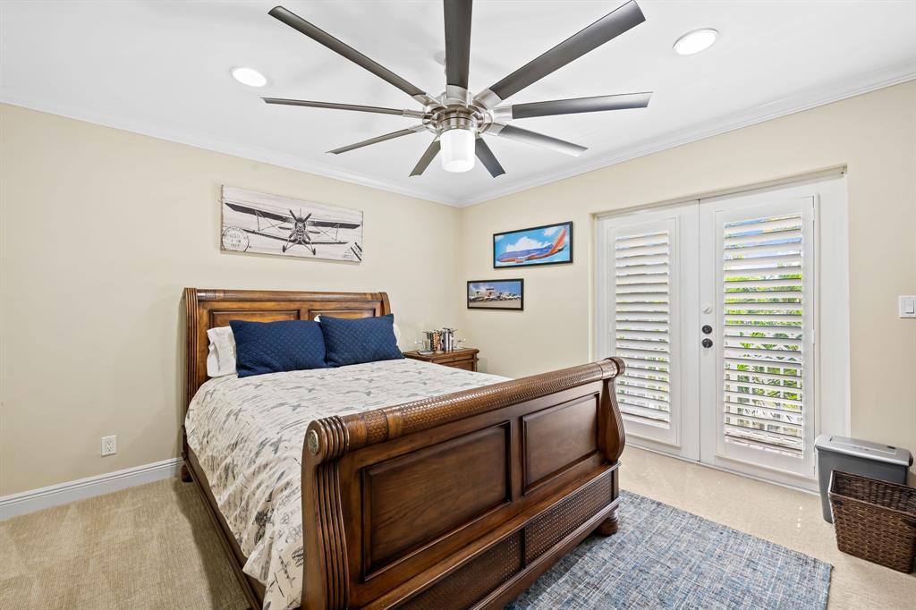 909 Turner Road Delray Beach, FL 33483 - Photo 28 of 50 a bedroom with a bed and a chandelier