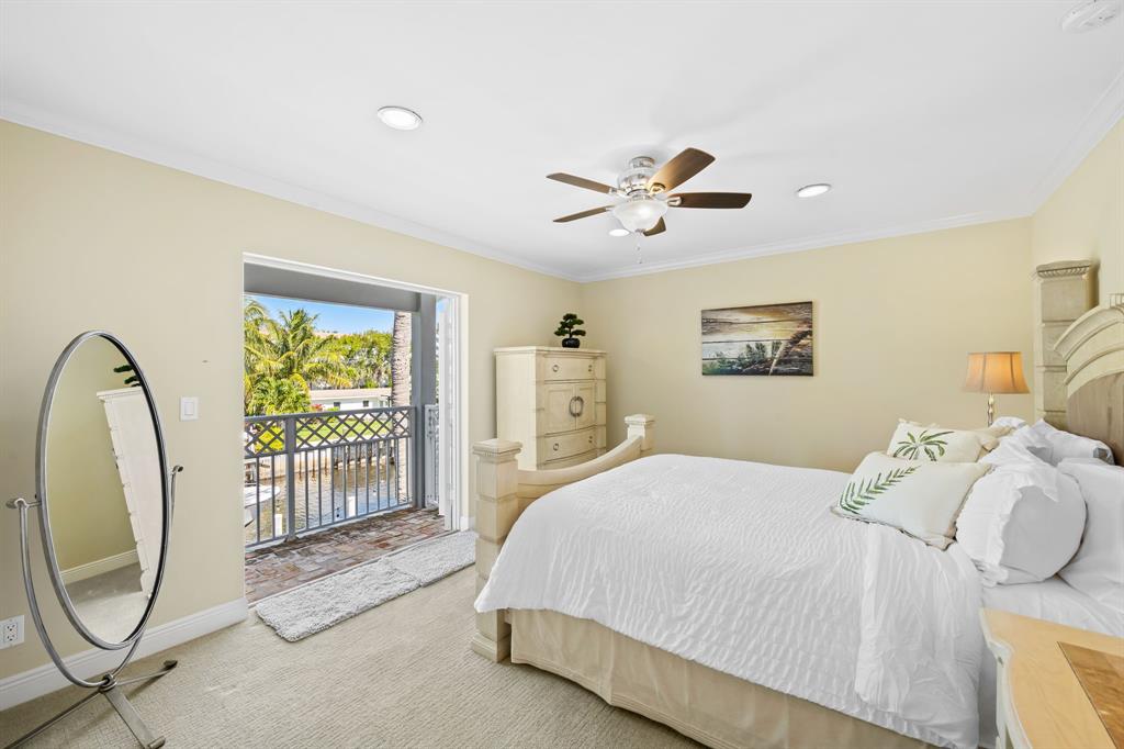 909 Turner Road Delray Beach, FL 33483 - Photo 31 of 50 a spacious bedroom with a bed and a chandelier