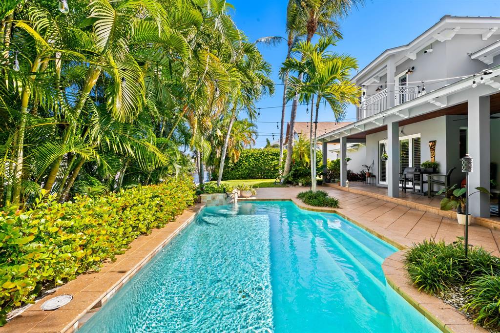 909 Turner Road Delray Beach, FL 33483 - Photo 37 of 50 a view of swimming pool with chairs and a yard