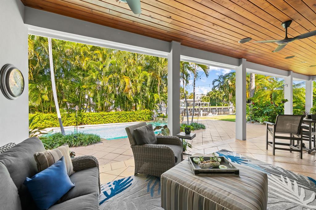 909 Turner Road Delray Beach, FL 33483 - Photo 39 of 50 a living room with furniture and a floor to ceiling window