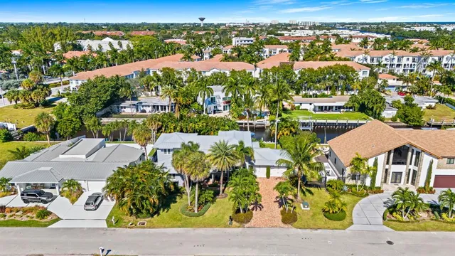 an aerial view of residential houses with outdoor space and street view