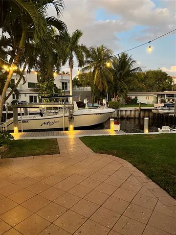 a view of swimming pool with outdoor seating and green space