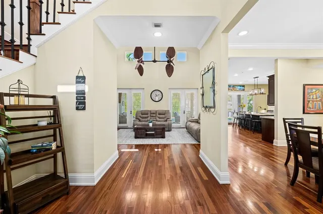 a view of a hallway with wooden floor and furniture