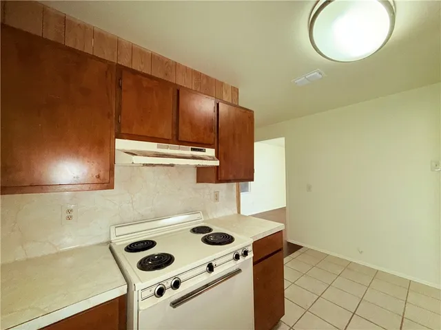 a kitchen with a sink cabinets and a wooden floor