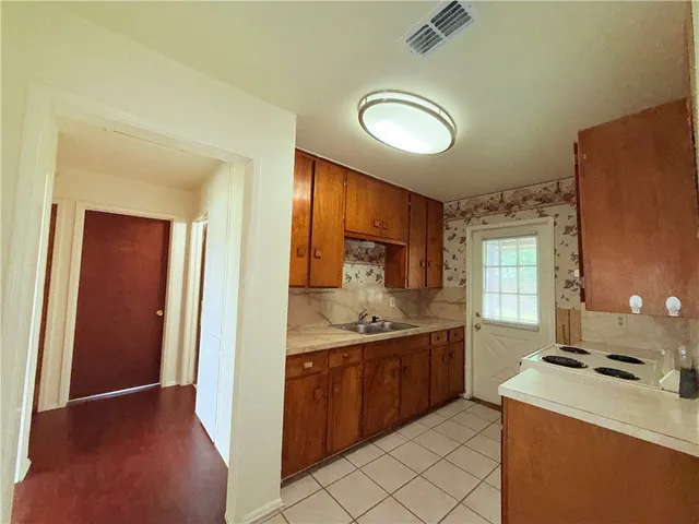 a kitchen with a sink stove and cabinets