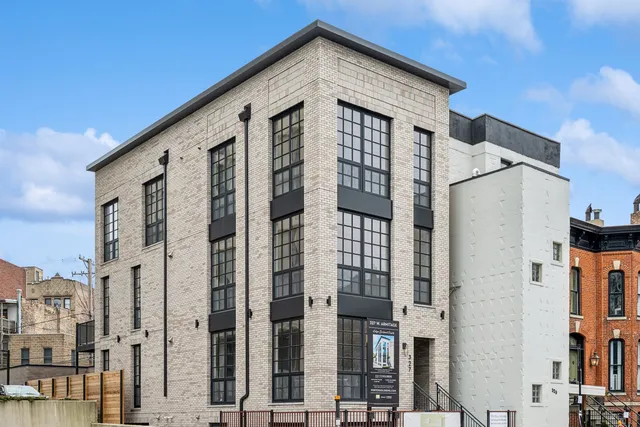 a front view of a house with large windows