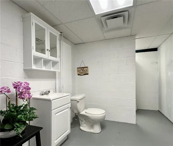 a white toilet sitting next to a bathroom sink