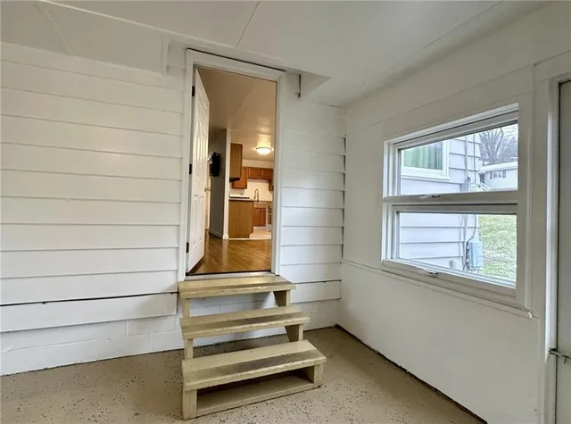 a view of room with window and wooden floor