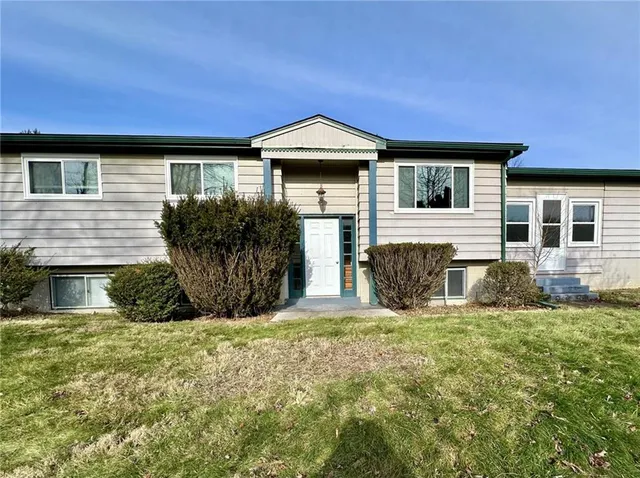 a front view of a house with a yard