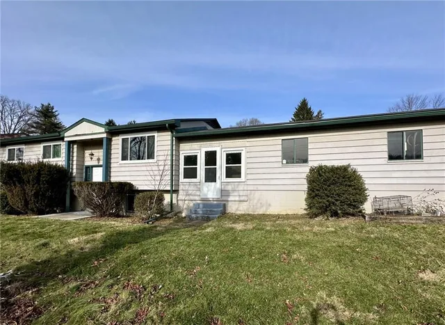 a view of a house with a yard