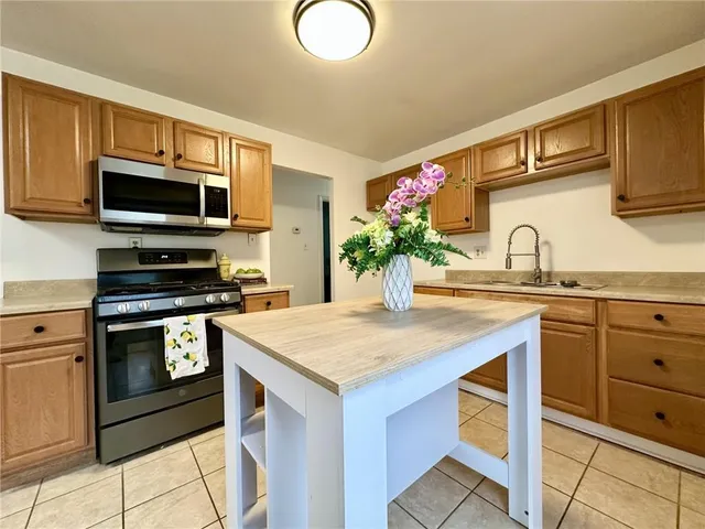 a kitchen with granite countertop a sink and stainless steel appliances