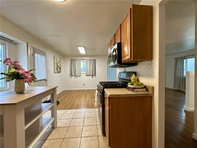 a kitchen with stainless steel appliances granite countertop a sink stove and cabinets