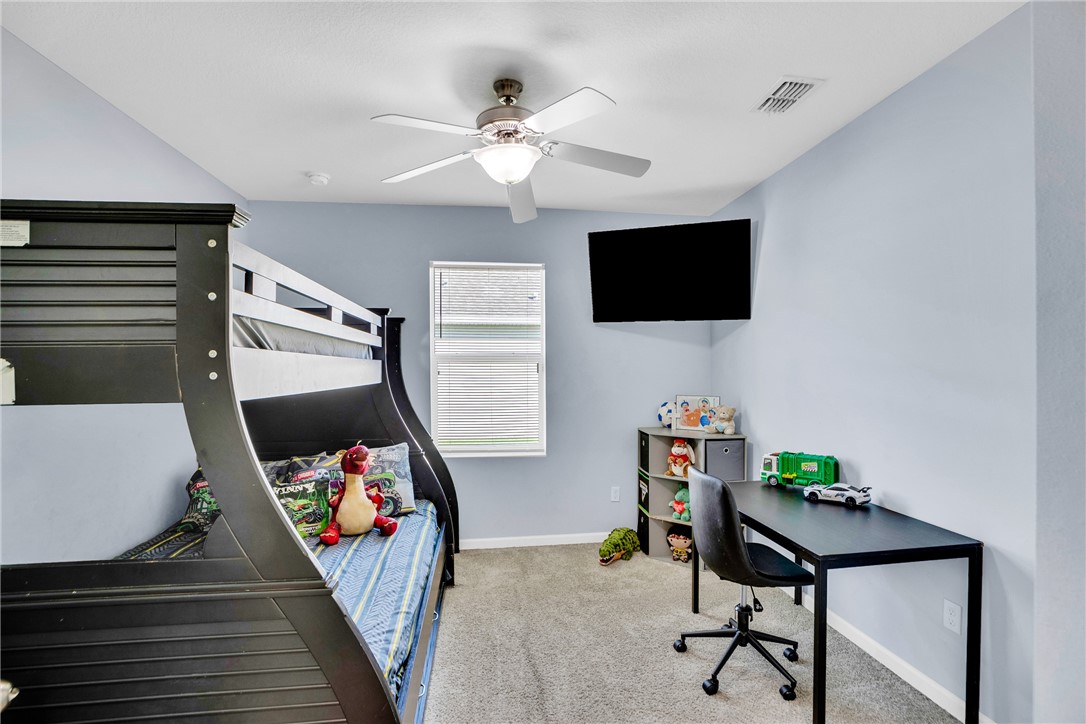 3453 Trinity Circle Fort Pierce, FL 34945 - Photo 23 of 36 a living room with furniture and a flat screen tv