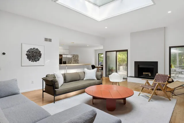 a living room with furniture a rug and a fireplace