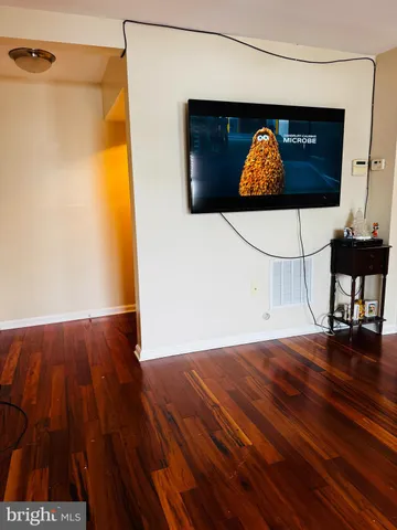 a living room with a couch and a potted plant