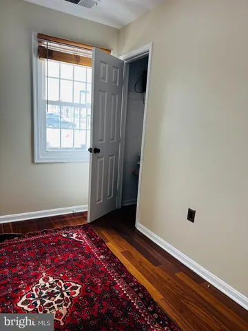 a room with chairs and a rug