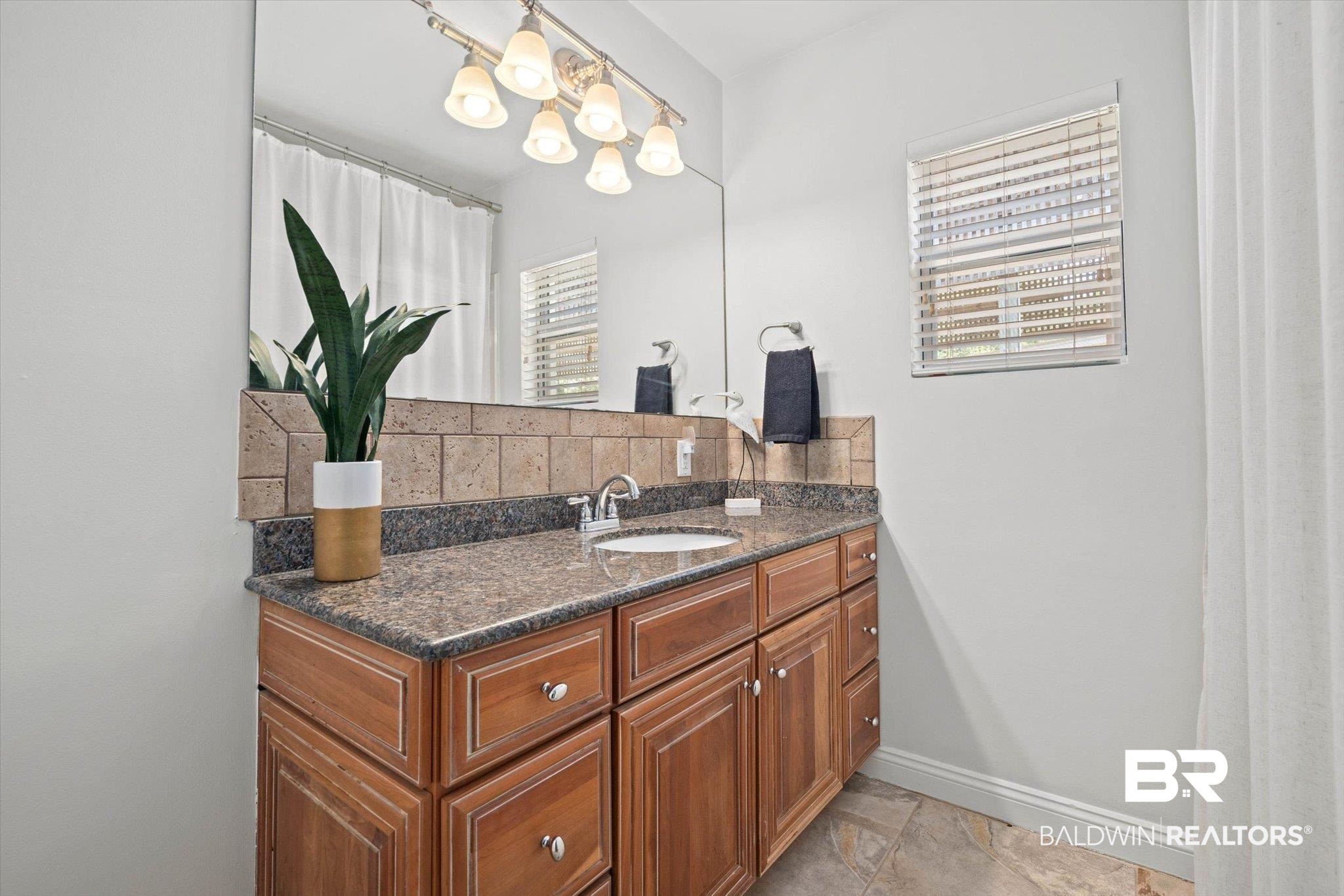 3720 Rabbit Creek Court Theodore, AL 36582 - Photo 15 of 47 Full bathroom featuring vanity, a shower with shower curtain, and light stone finish floors