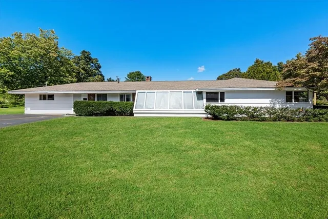 a view of house with a yard
