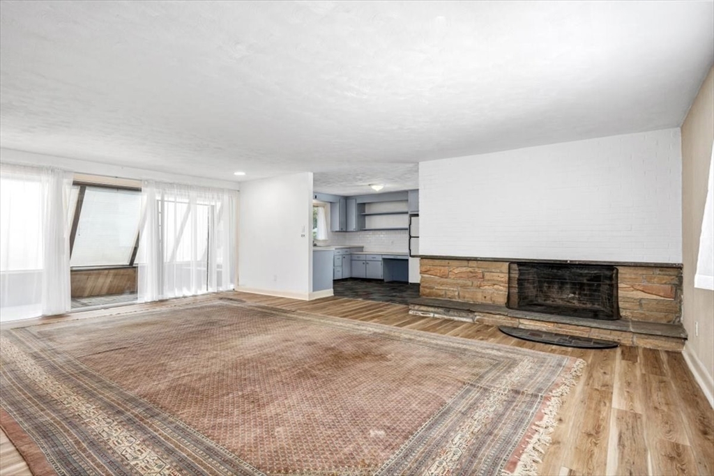 4 Richard Road Hingham, MA 02043 - Photo 11 of 37 a view of empty room with a fireplace and windows