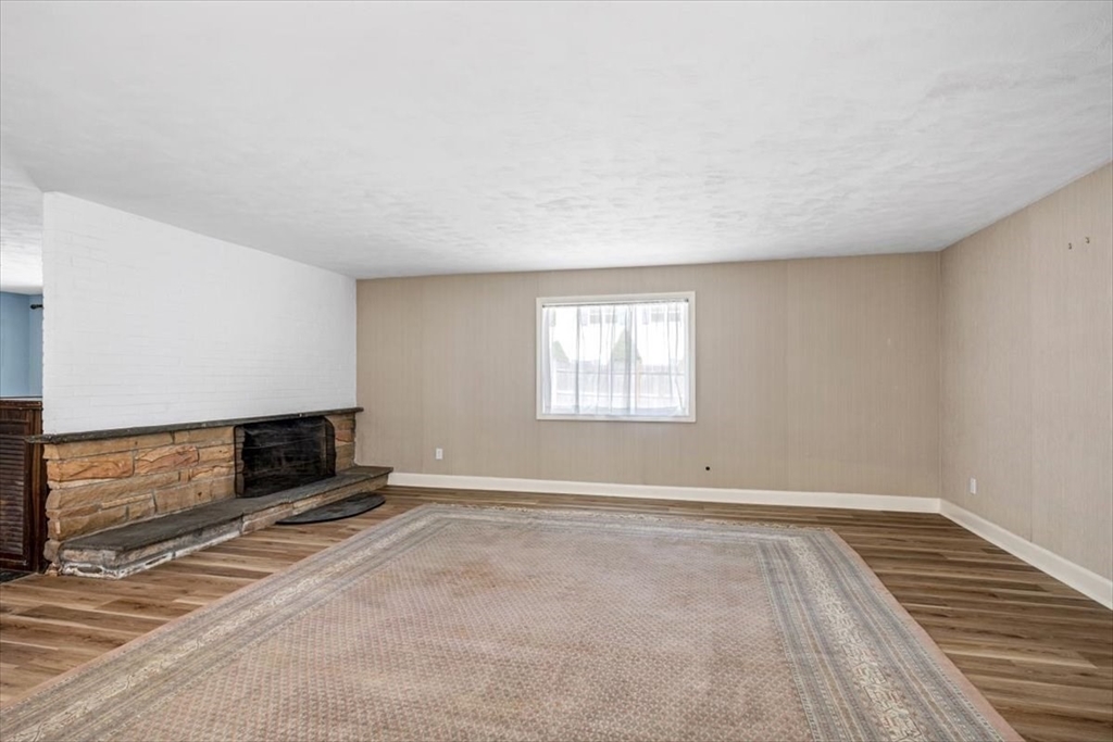 4 Richard Road Hingham, MA 02043 - Photo 13 of 37 a view of an empty room with wooden floor and a window