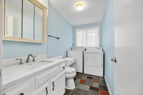a view of a hallway with wooden floor and entryway