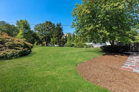 a garden with trees in the background