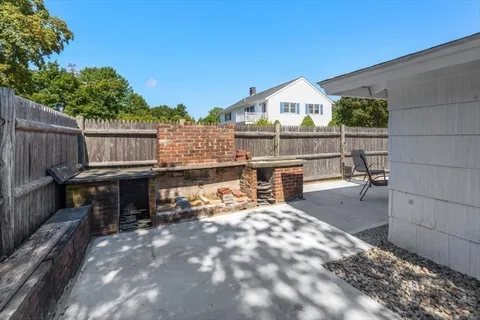 a view of a house with pool and brick wall