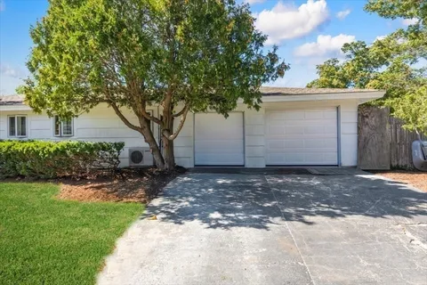 a view of a city with lush green forest