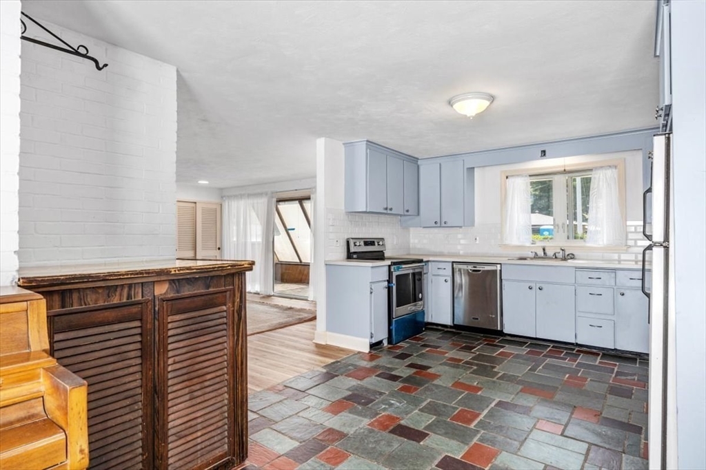 4 Richard Road Hingham, MA 02043 - Photo 9 of 37 a kitchen with granite countertop a sink cabinets and stainless steel appliances