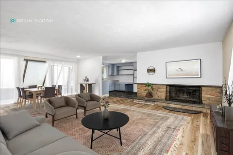 a view of empty room with a fireplace and windows