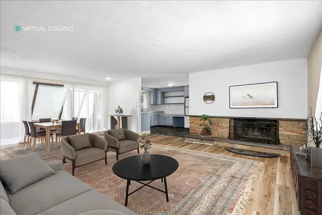 a view of empty room with a fireplace and windows