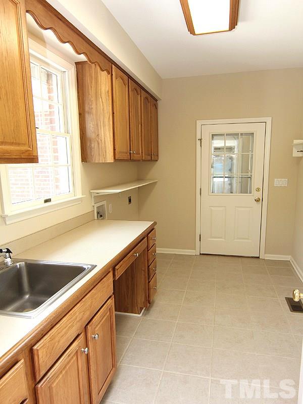 3795 Dick Holeman Road Timberlake, NC 27583 - Photo 7 of 18 Come in from Garage or side door..plenty of space...desk, sink, washer dryer location and cabinets!