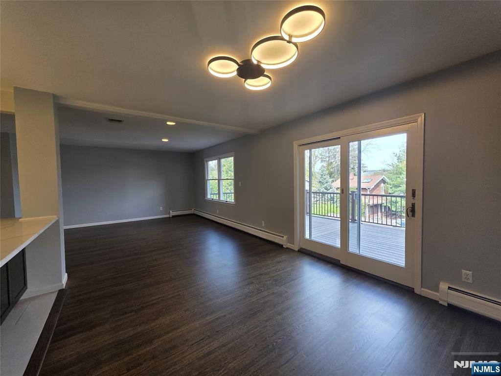 194 8th Street Cresskill, NJ 07626 - Photo 12 of 34 a view of an empty room with wooden floor and a window