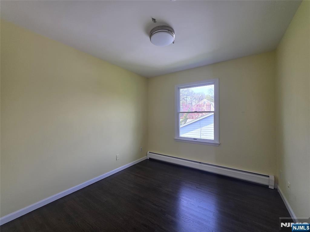 194 8th Street Cresskill, NJ 07626 - Photo 25 of 34 an empty room with wooden floor and windows
