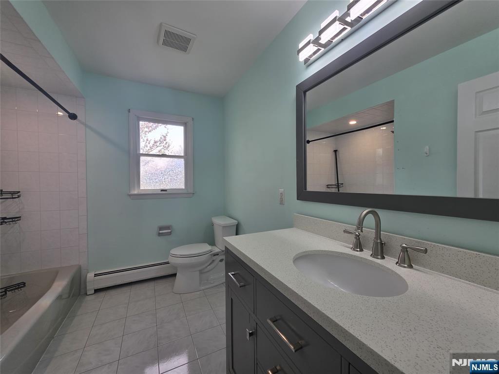 194 8th Street Cresskill, NJ 07626 - Photo 26 of 34 a bathroom with a toilet sink and mirror