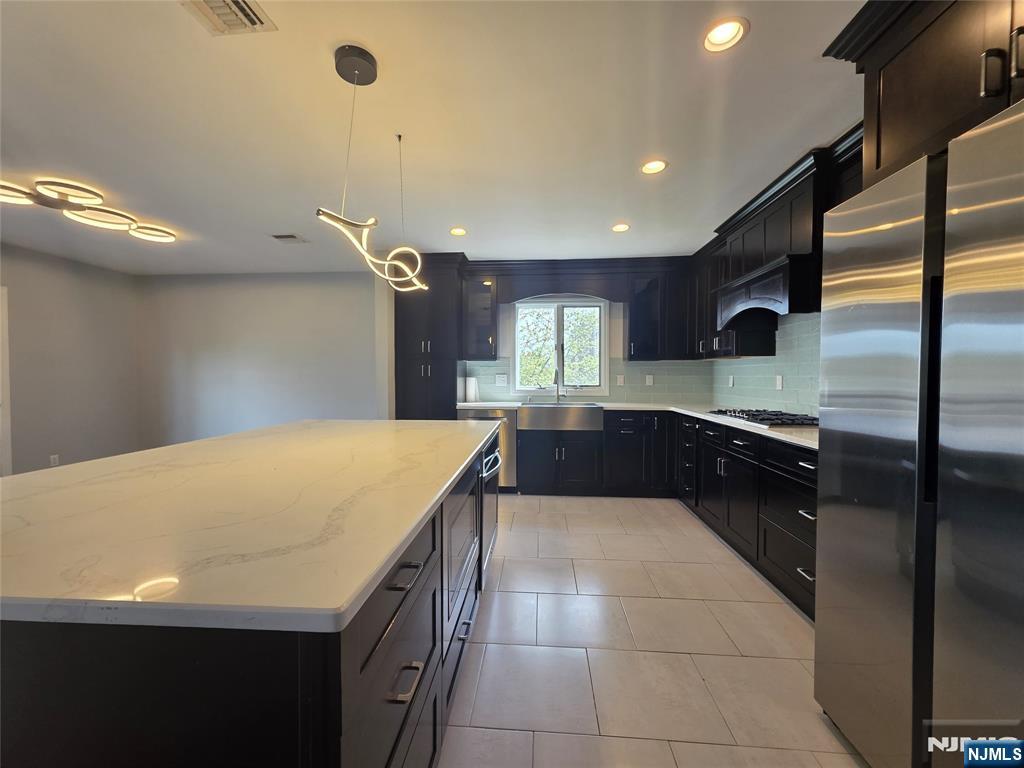 194 8th Street Cresskill, NJ 07626 - Photo 6 of 34 a kitchen with a sink a counter top space and appliances