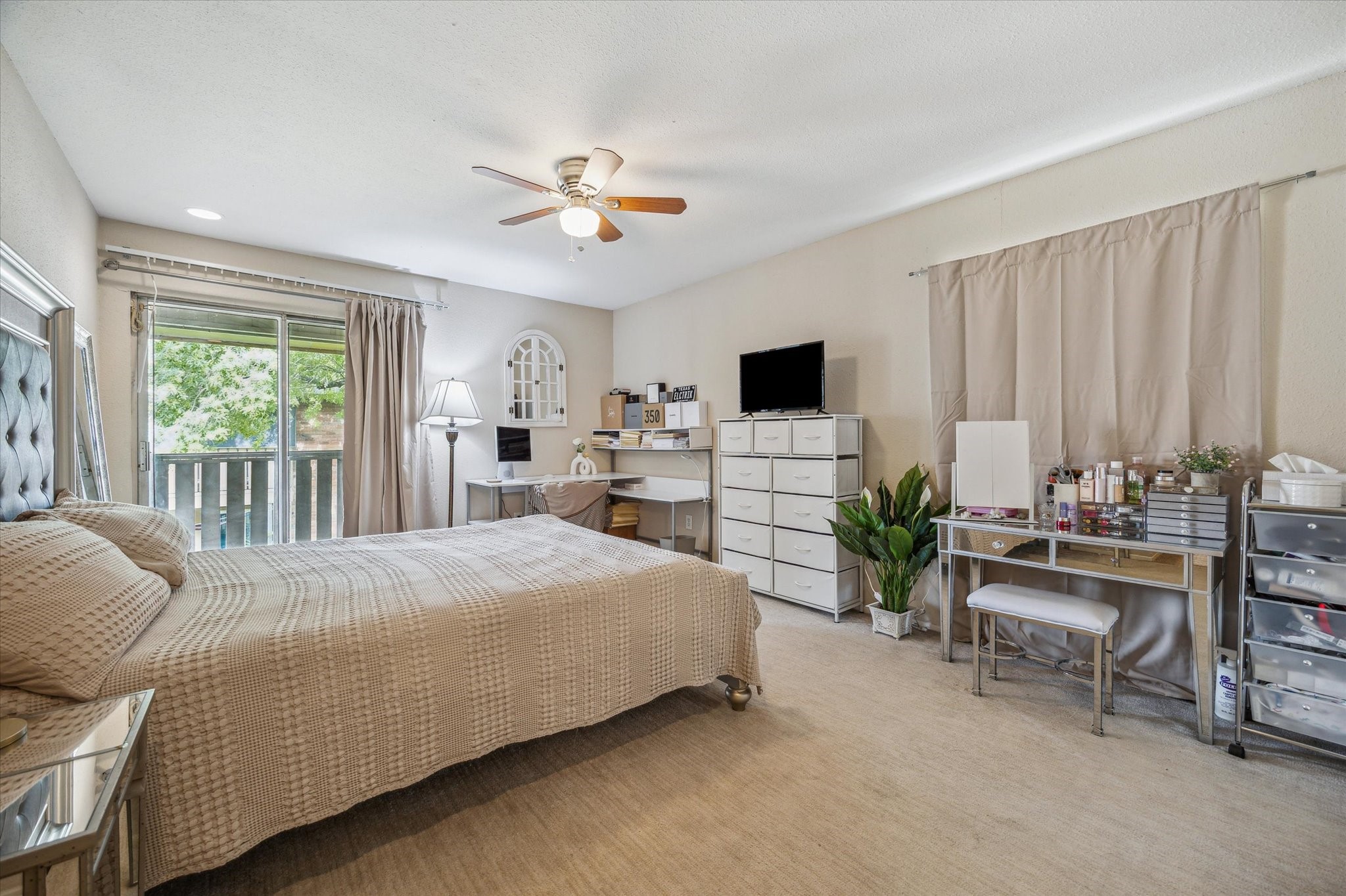 5667 Birchmont Drive, Unit A Houston, TX 77091 - Photo 12 of 18 a bedroom with a large bed and a chandelier