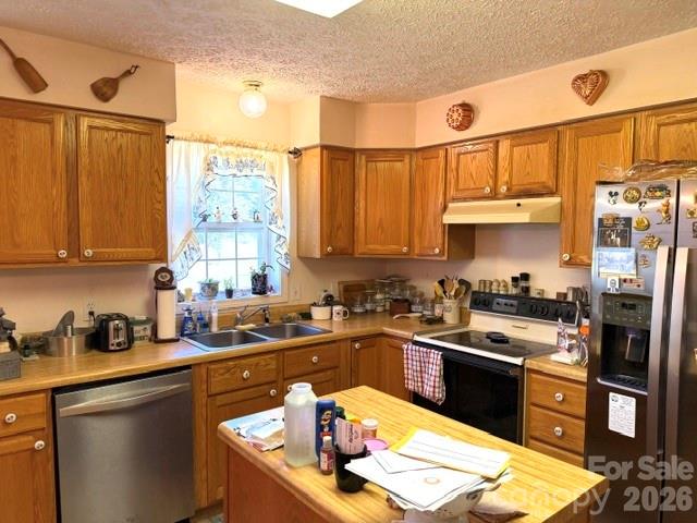 4084 Carpenters Cove Road Claremont, NC 28610 - Photo 13 of 27 a kitchen with stainless steel appliances granite countertop a sink a stove and refrigerator