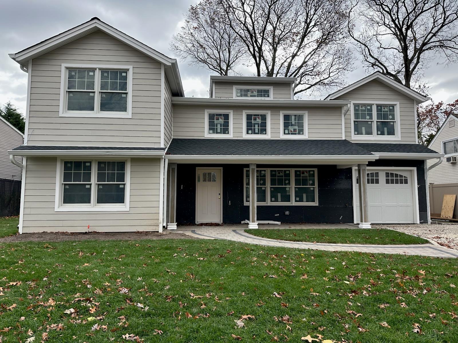 a front view of a house with a yard