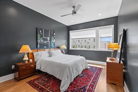 a bedroom with a bed and wooden floor