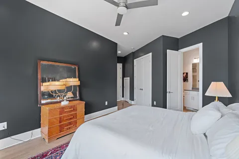 a bathroom with a granite countertop sink a toilet and shower