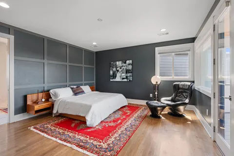 a bed room with a bed and glass windows