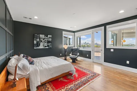 a utility room with wooden floor washer and dryer
