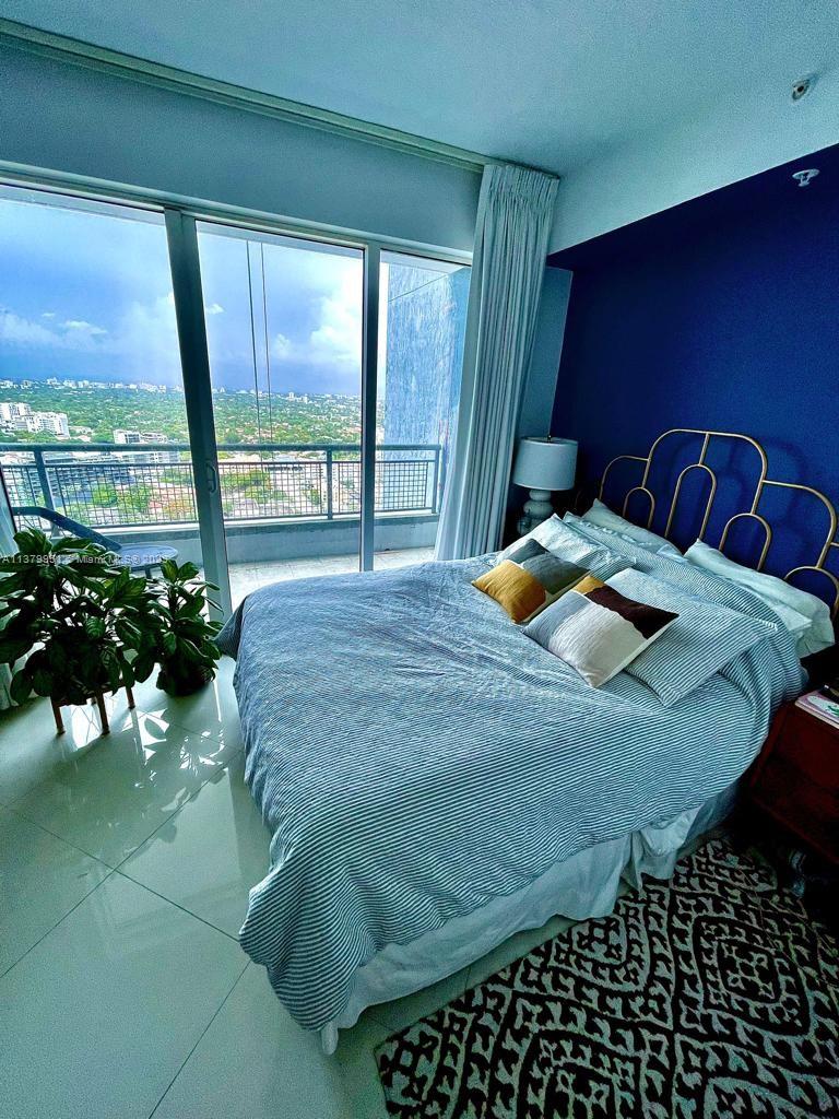 60 Southwest 13th Street, Unit 2413 Miami, FL 33130 - Photo 11 of 27 a bedroom with a bed and window