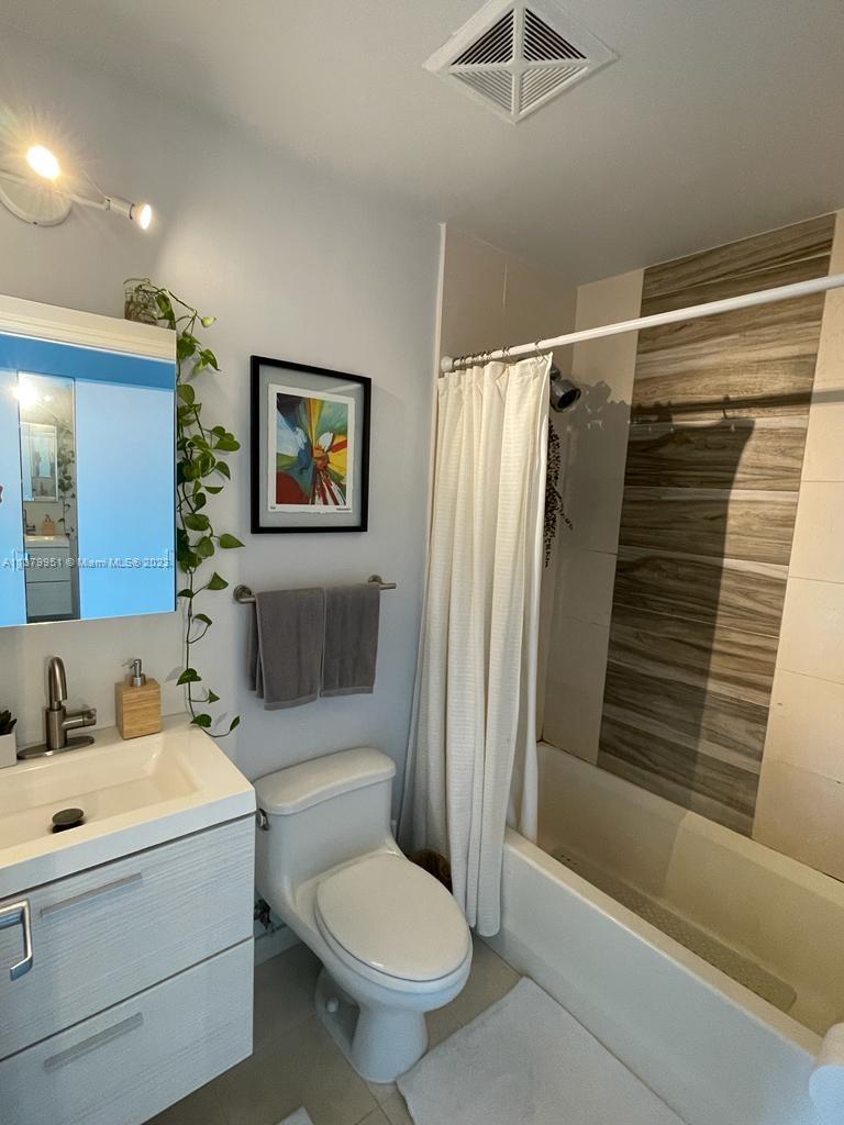 60 Southwest 13th Street, Unit 2413 Miami, FL 33130 - Photo 13 of 27 a bathroom with a sink toilet and shower