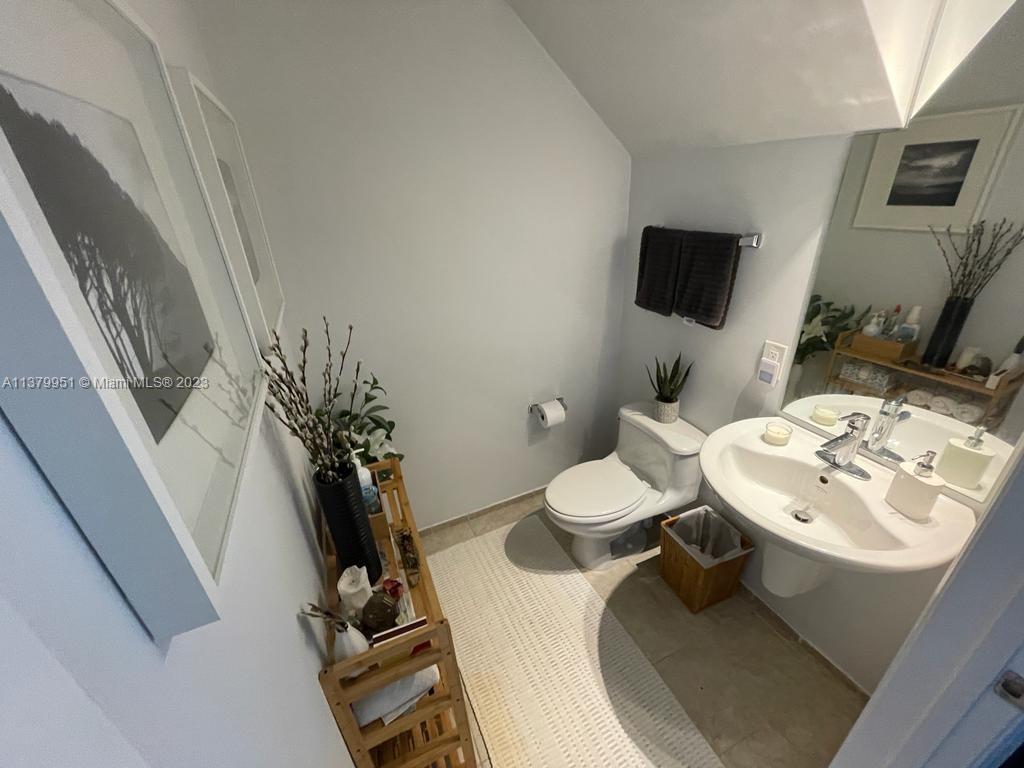 60 Southwest 13th Street, Unit 2413 Miami, FL 33130 - Photo 16 of 27 a bathroom with a sink toilet and mirror