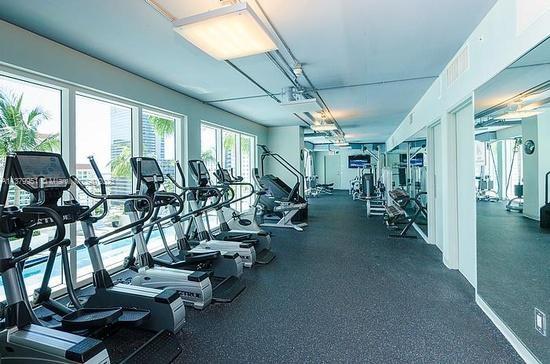 60 Southwest 13th Street, Unit 2413 Miami, FL 33130 - Photo 21 of 27 a view of a room with gym equipment