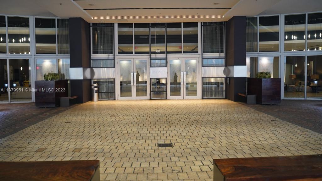 60 Southwest 13th Street, Unit 2413 Miami, FL 33130 - Photo 4 of 27 an empty room with wooden floor and windows